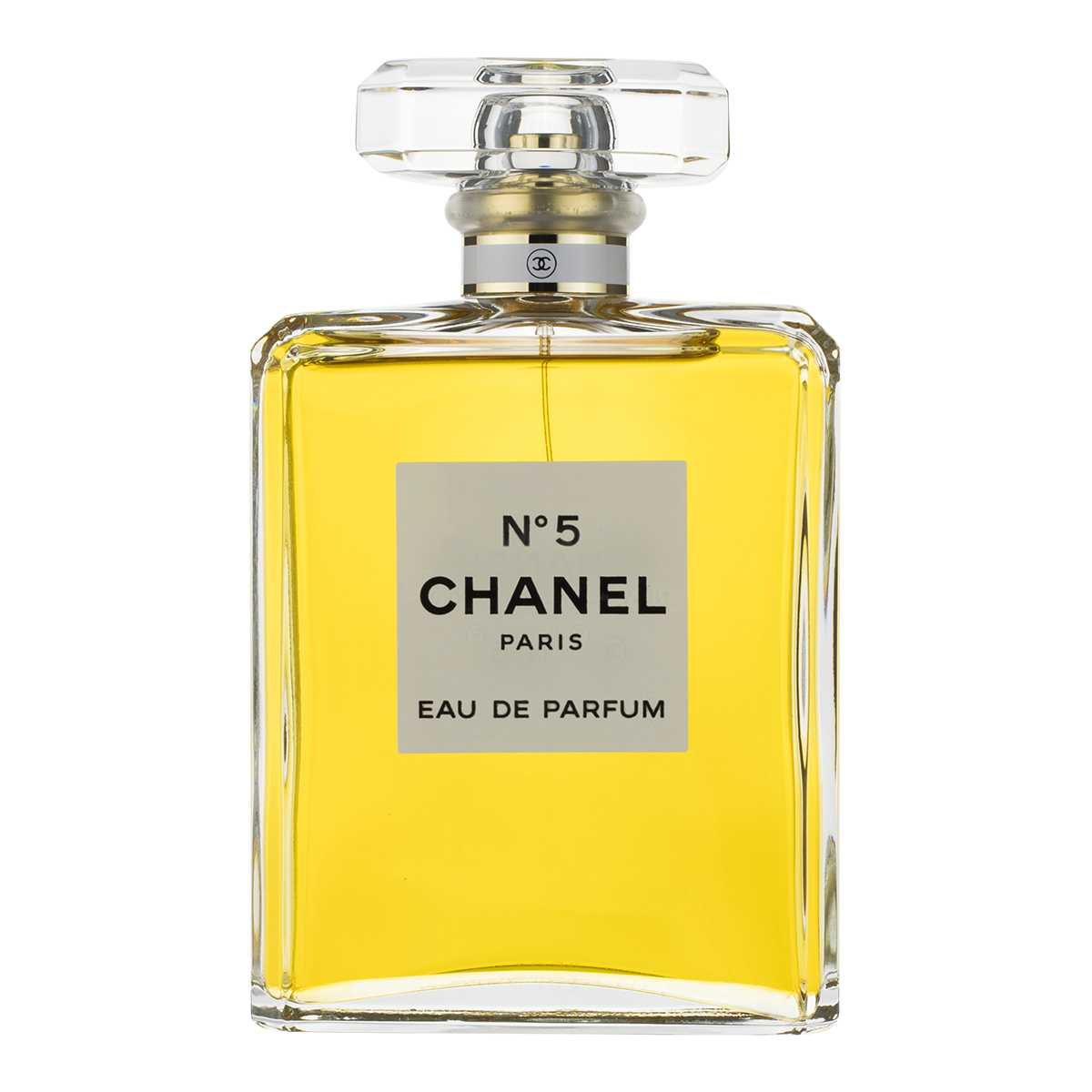 Chanel N°5 Eau de Parfum bottle — clear rectangular glass with pale gold liquid and a geometric stopper
