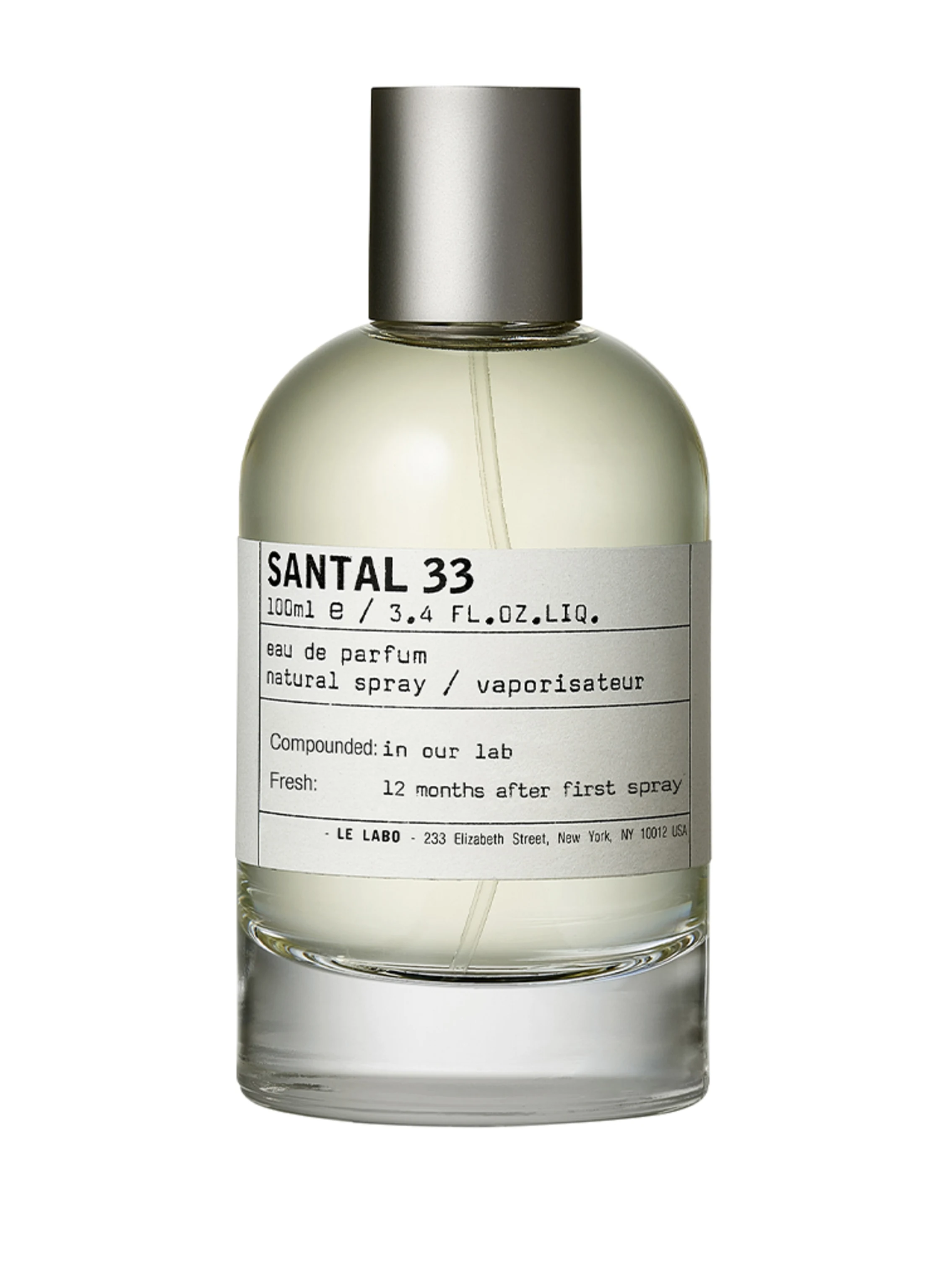 Le Labo Santal 33 bottle — clear laboratory-style glass with a large white pharmacy label